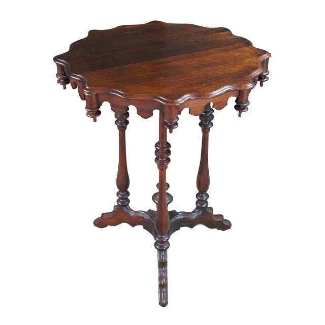 Antique Victorian Gothic Revival style pedestal table. Made of walnut featuring scalloped form with turned supports,...