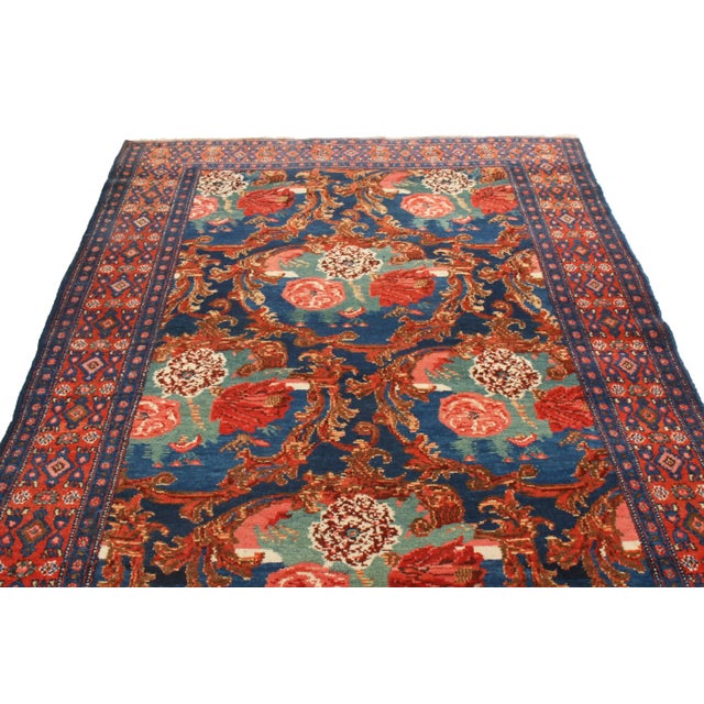 Originating from Persia in 1910, this antique traditional Senneh Persian rug enjoys a distinguished array of colourways in...