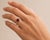 This solitaire ring features a 1.75 carat round-cut natural ruby set in 14K yellow gold. The striking natural ruby in a...