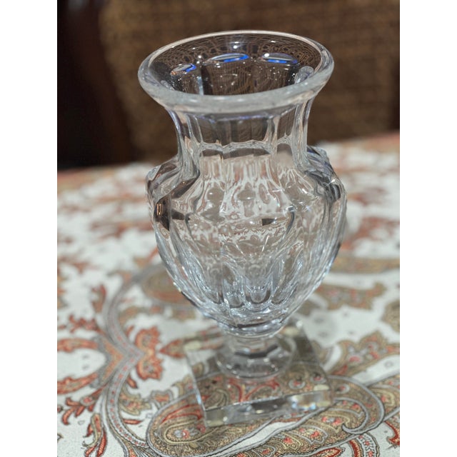 This is a Baccarat Marie Louise crystal vase. It features vertical cuts, a band of raised diamond cut detailing around the...