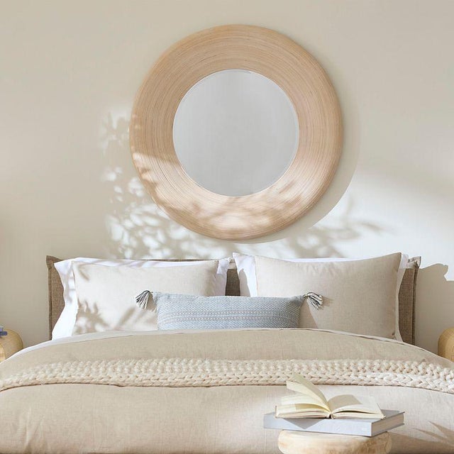 The simple circular lines of this wood mirror are beautifully enhanced by linear textural elements. Artisan-crafted from...