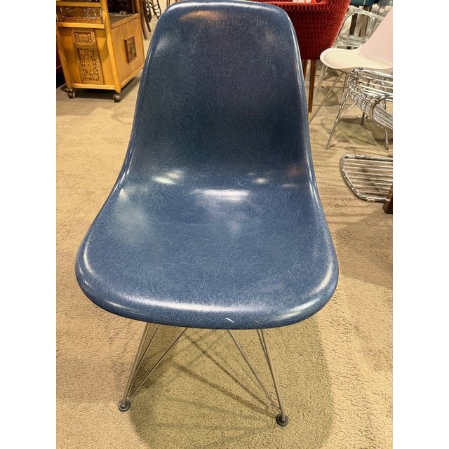 An iconic expression of mid-century modern design, this set of six Herman Miller fiberglass shell chairs by Charles and...