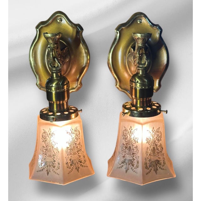 This set of sconces has a quaint, yet elegant charm. The brass backplates have a shiny golden rim that fade into a warm...