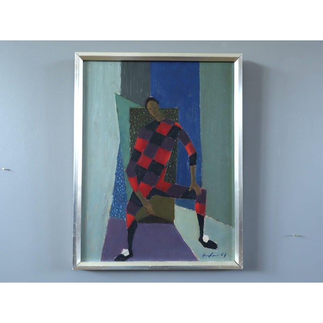 SEATED HARLEQUIN Size: 14.8 x 11.6 inches (including frame) Oil on board A mid-century figurative painting where a...