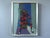 SEATED HARLEQUIN Size: 14.8 x 11.6 inches (including frame) Oil on board A mid-century figurative painting where a...