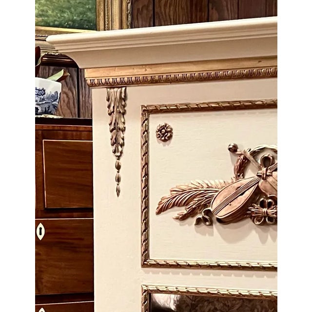This all wood trumeau mirror is a reproduction of an 1800’s piece. It is painted a neutral beige with old gold accents. It...