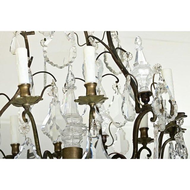 Dimensions: 43 ¼” H x 27 ½” W x 27 ½” D A spectacular French 19th century Louis XVI style nine light bronze and crystal...