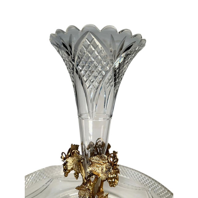 A gilded 19th century cut crystal Epergne adorned with intricate grapes and vines detailing. A stunning piece from circa...