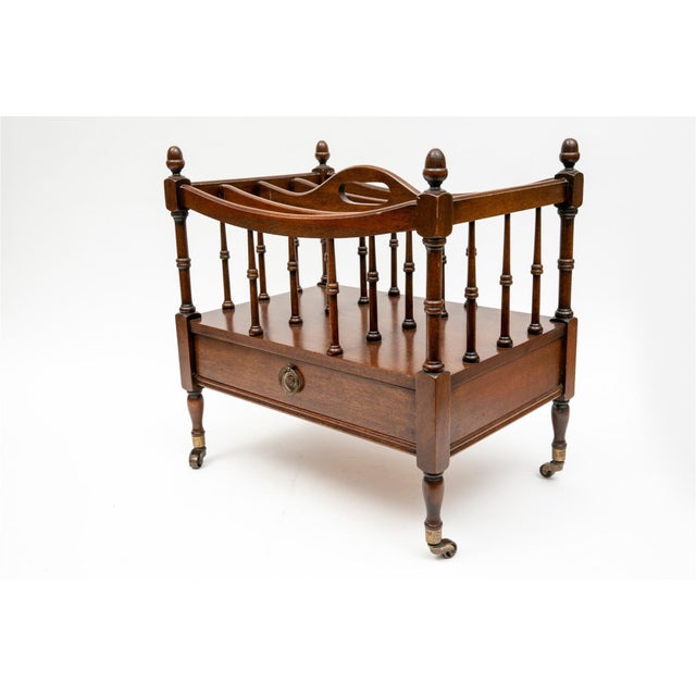 A mahogany Regency style Canterbury rack for sheet music or magazines with four divided compartments formed by turned...
