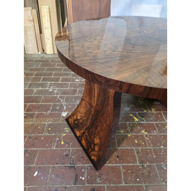An elegant Art Deco occasional table dating from circa 1930, distinguished by its circular burr walnut top, featuring...