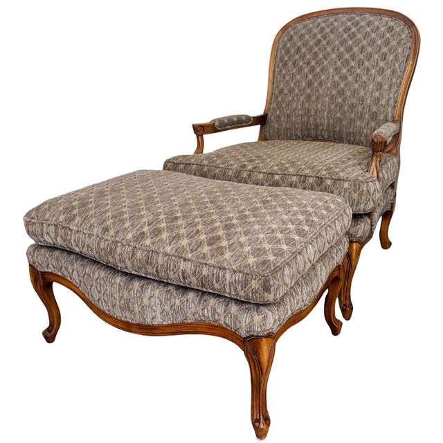 An elegant French Provincial style bergère and matching ottoman featuring a classic curved silhouette and a sophisticated...
