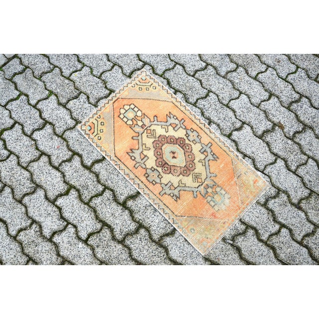 This is a vintage Turkish Oushak rug from the 1960s. The piece was hand-knotted.