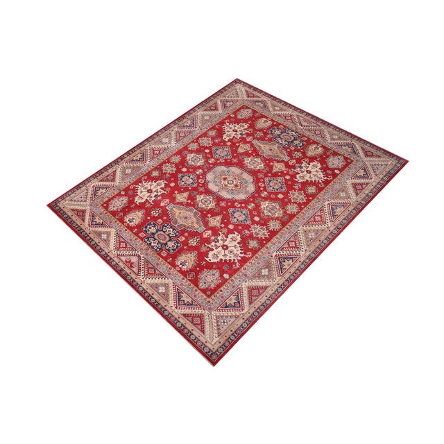 Enhance your home with this exquisite hand-knotted Kazak rug, crafted from fine hand-spun wool and dyed with all-natural...