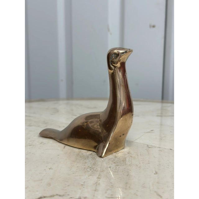 This is a vintage collectible solid brass seal figurine or paperweight. It is about 4 inches tall and is in good used...