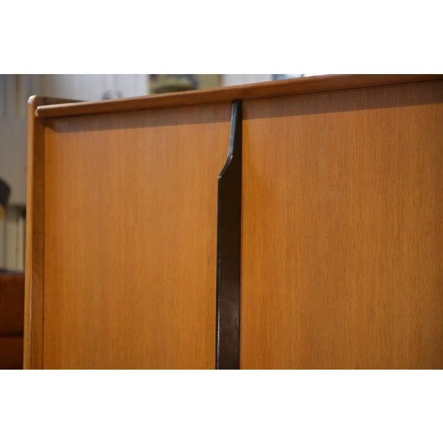 Light wood wardrobe, attributed to Roger Landault, 1960s. The clean lines of the front feature two flat doors, punctuated...