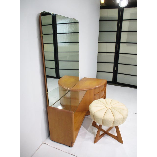 An exceptional vanity set with large mirror three drawers and with the original revolving X based pouffe stool in the...