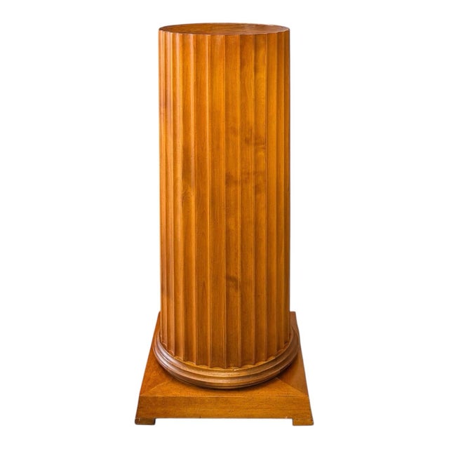 A neoclassical pedestal of robust proportions having an inset top of figured walnut. The fluted column rests upon a...