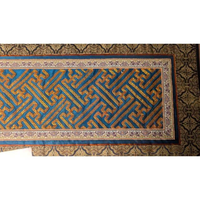 This piece is a remarkable survivor from the late Qing Dynasty era. The central 'Wan' pattern, or infinite fretwork, was a...