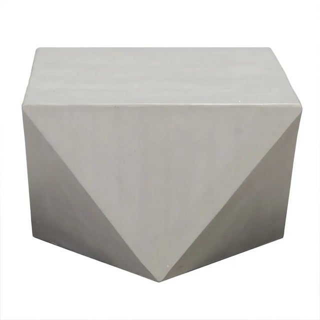 The Bota Coffee/Side Table is a fusion of modern design and resilience, constructed from Fiber Cement with an As Is...