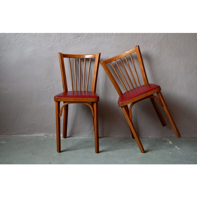 A classic piece of vintage furniture, this pair of bistro chairs, in perfect condition, is a product of the Baumann...