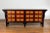 A Chinese Qing Dynasty period long sideboard from the 19th century with black lacquer structure, 12 drawers adorned with...