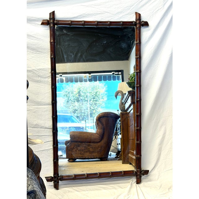 This French faux bamboo mirror is a rare find. Seldom are they found in this size and in this dark wood finish....