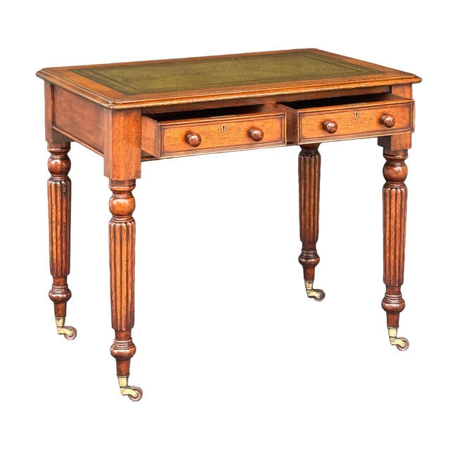 A fine English library table or writing desk of beautiful patinated oak from the William IV period, featuring a moulded...