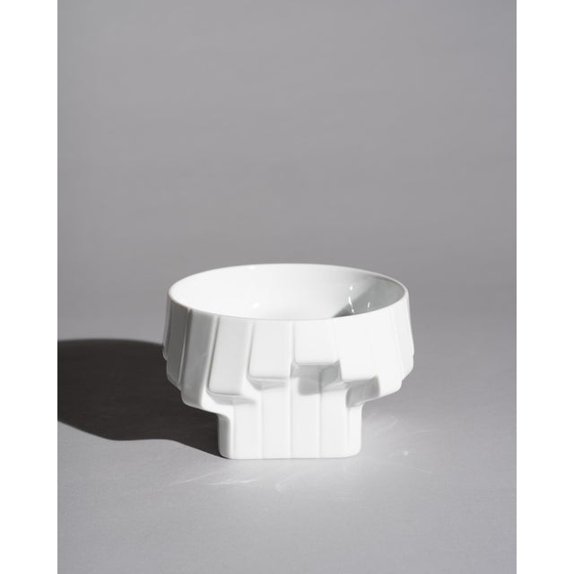 A sculptural porcelain bowl designed by Zaha Hadid for Rosenthal, translating the architect's signature language of fluid...