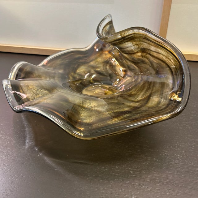 Blown art glass bowl in gold brown and copper color swirls.