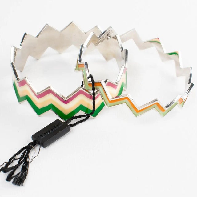 These stunning Missoni, Italy bracelet bangles feature a zig-zag shape with enamel decor. The silvered metal framing is...