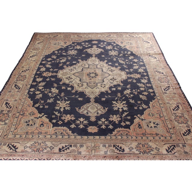 An 8x10 hand-knotted antique Oushak rug, originating from Turkey circa 1920-1930. Finely woven in wool, the rug enraptures...