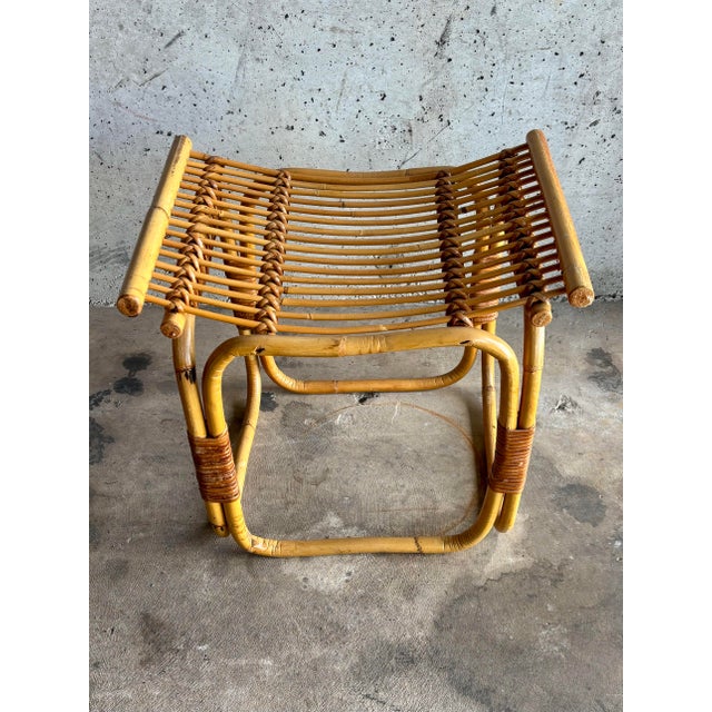 A sculptural 1960s Italian rattan and cane stool in the style of Franco Albini, embodying the lightness and architectural...