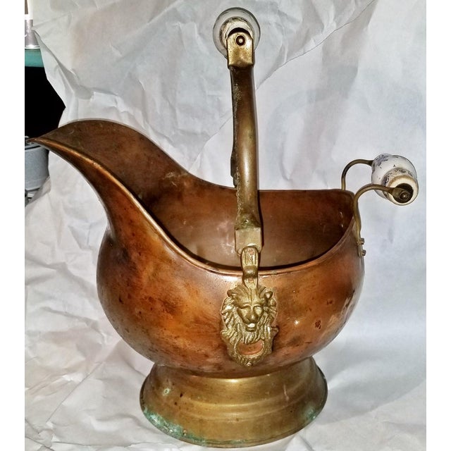 Fun 1970s copper, brass and delft ceramic handled fireplace coal scuttle bucket with lionhead hinges well loved with...