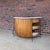 A classic Mid-Century Modern tiki bar in the style of Arthur Umanoff, featuring a curved bamboo façade, black wrought iron...
