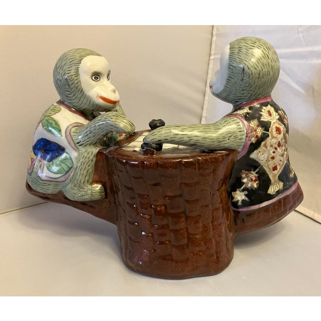 Unusual porcelain figure of two monkeys playing a board game. Made in China in the 1990s the piece measures 8 1/2”h x 11...
