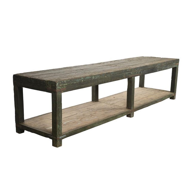 Large old teak table with green patina. This piece is designed in the style of the selected designer and/or manufacturer