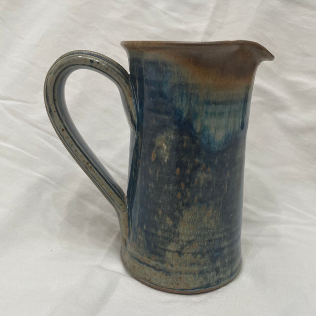 This functional stoneware studio pottery pitcher by Wellman and Welsch embodies their boho country aesthetic. With its...