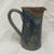 This functional stoneware studio pottery pitcher by Wellman and Welsch embodies their boho country aesthetic. With its...