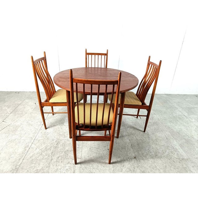 Elegant mid century scandinavian dining set consisting of 4 spindle chairs and a round dining table. The chairs and table...