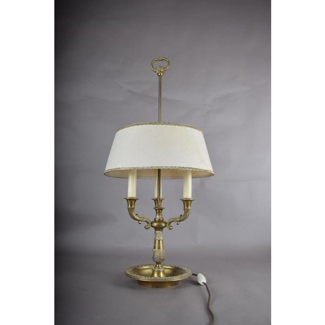The bouillotte lamp takes its name from a French card game played late into the evening, when a table needed steady light...