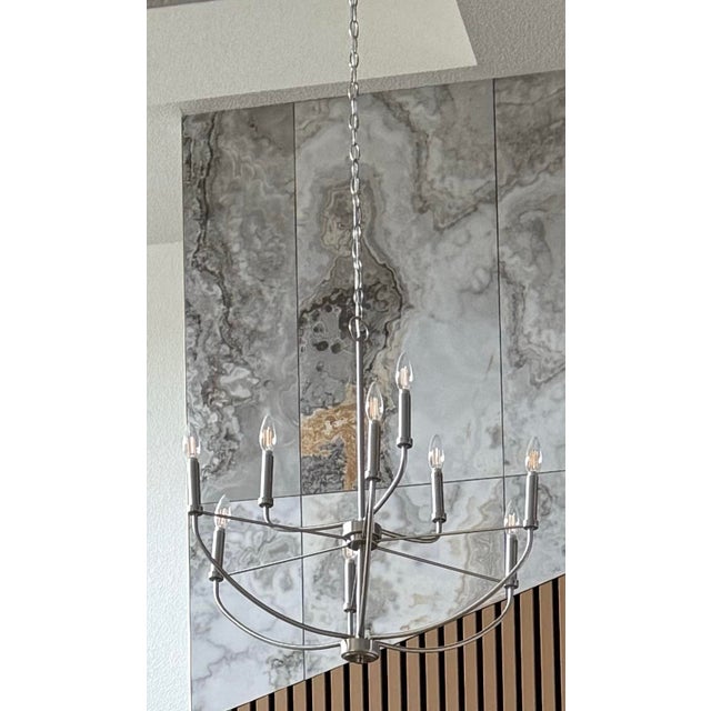 Brand new silver chandelier from Scott Felder Homes. Never used or installed. Features a sleek candle-style design with 10...