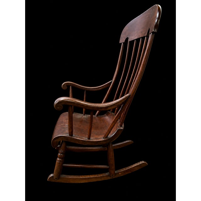 This exceptional vintage American Windsor-style rocking chair beautifully balances classic early American form with a...