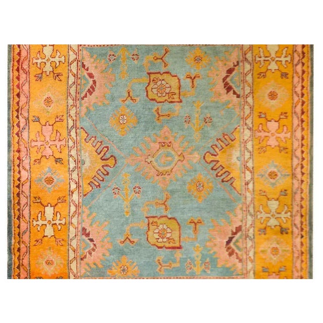 An exciting and bold early 20th century Turkish Oushak rug with a wonderful large-scale stylized floral patterned field...