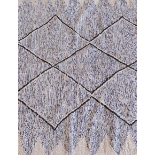 Crafted in Morocco, the Moroccan Kilim Zanafi flatweave rug measures 9.1 x 4.9 ft / 278 x 150 cm. Its minimalistic design...