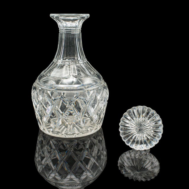 This is a vintage brandy decanter. An English, cut crystal glass bulb form spirit vessel, dating to the mid century...