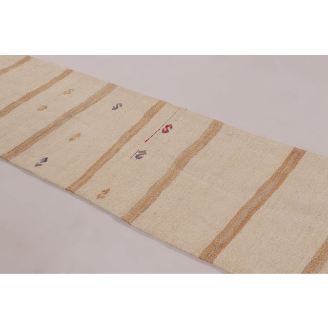 Handwoven in hemp circa 1950-1960, this 3x9 vintage Anatolian runner rug is a refined example of minimalist textile...