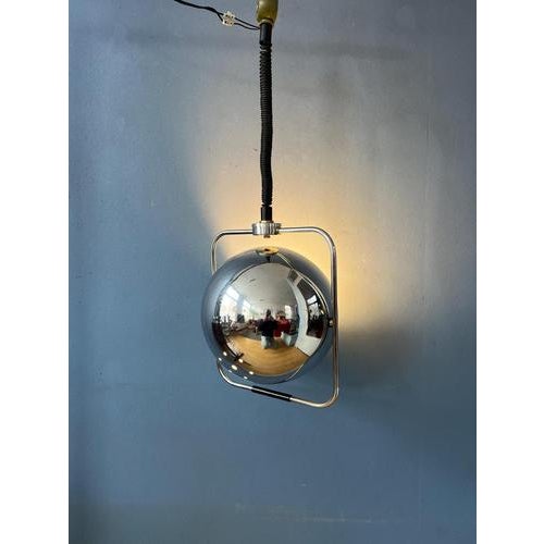 Chrome mid century space age eyeball pendant lamp by GEPO. This playful lamp can turn its shade all around its axis. It...