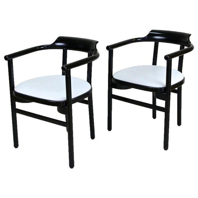 Amazing looking pair of black lacquered 20th century armchairs made by the renowned company of Thonet Vienna. These...