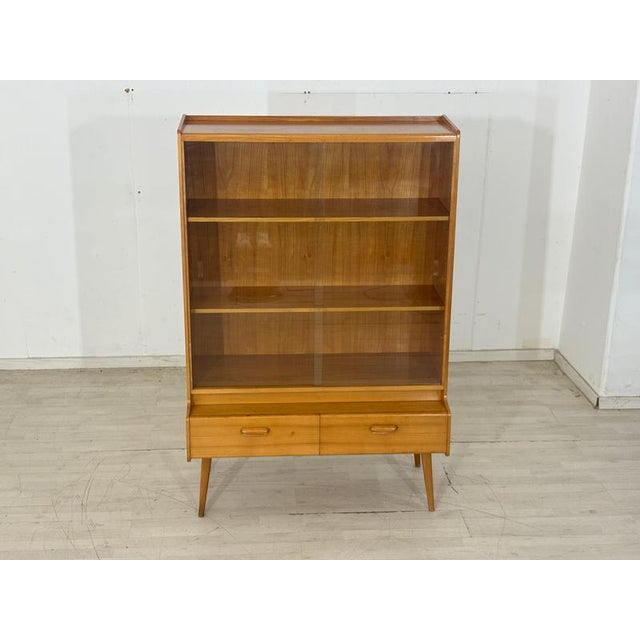 Elegant mid-century display cabinet from the 1960s. This piece of furniture impresses with its simple, period-typical...