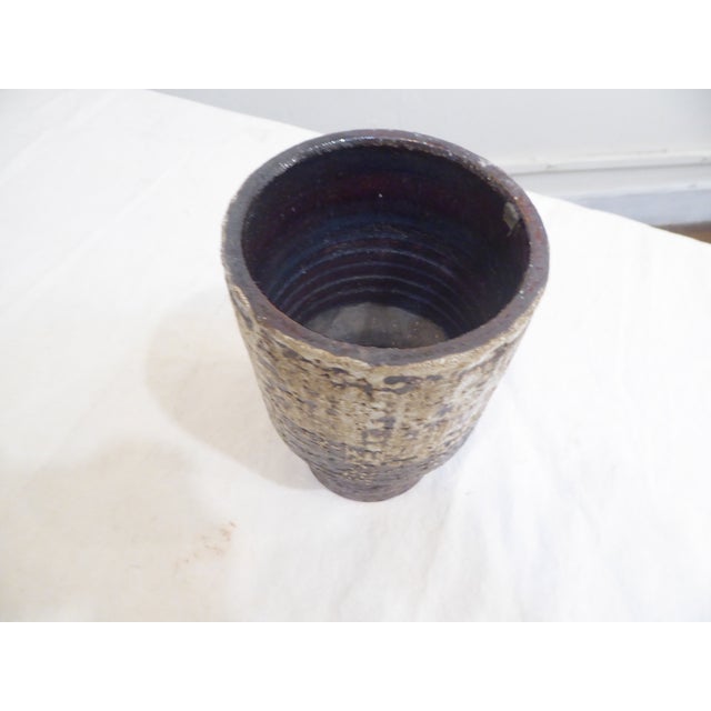 This mid-20th century hand thrown vase is possible West German, though it is not marked on the underside.